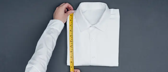 a person measuring a shirt