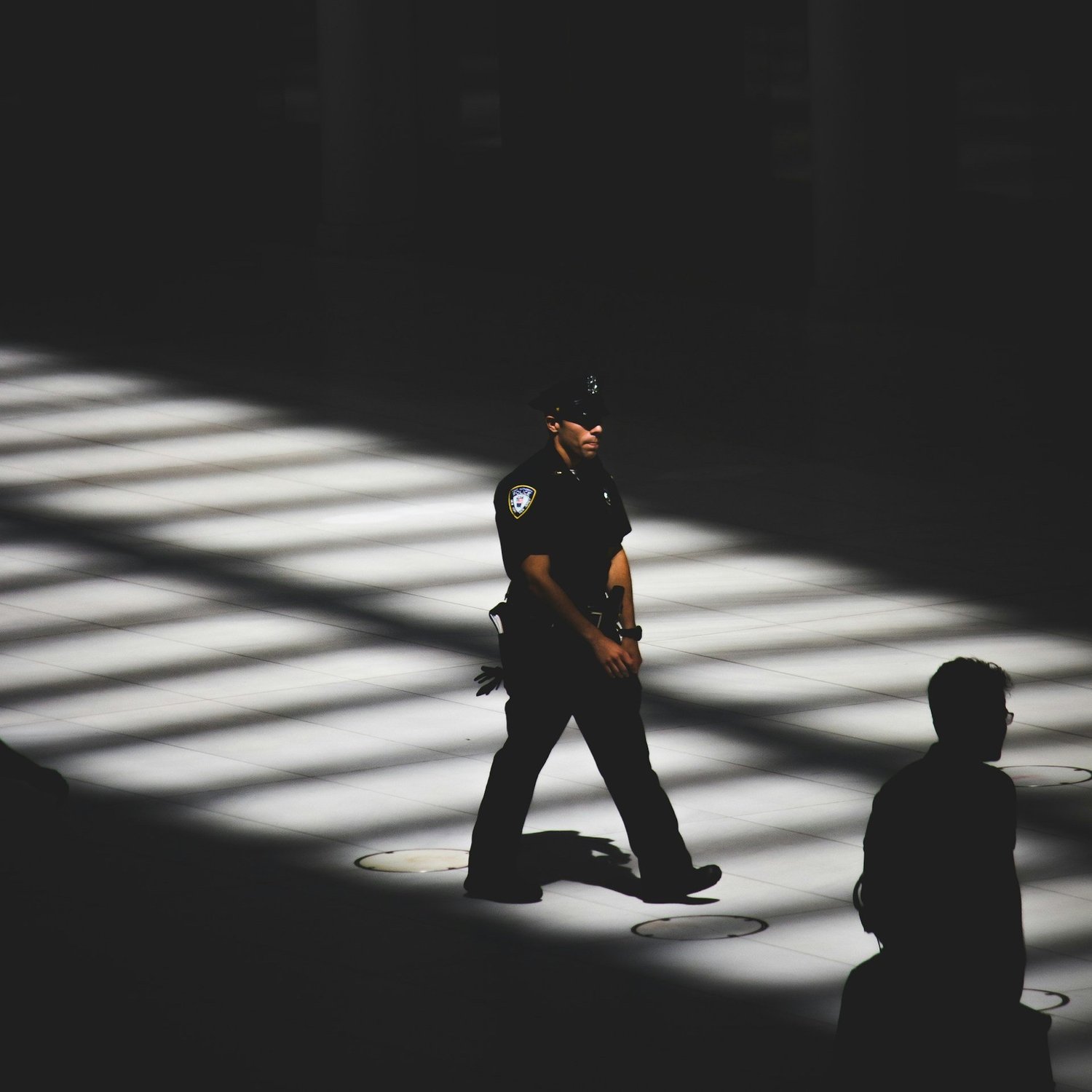 a police officer walking in a dark room