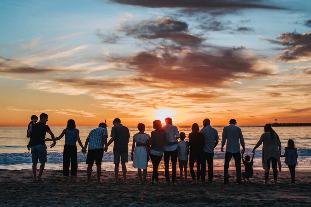 a group of people standing on a beach