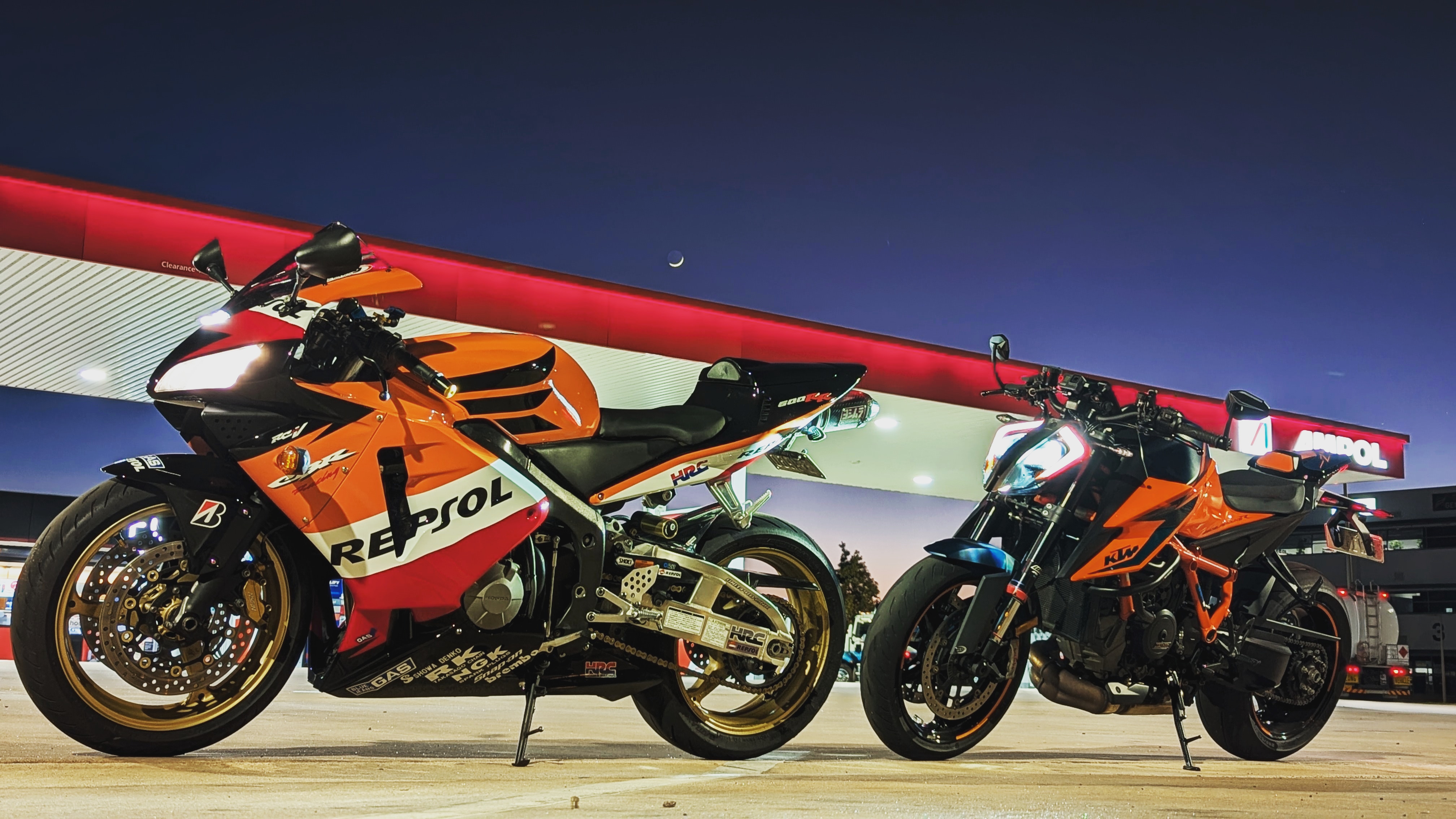 two motorcycles parked on a concrete surface