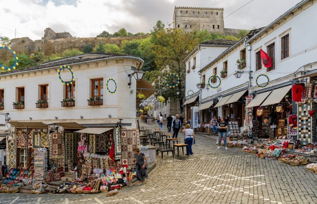 a street with shops and people walking around