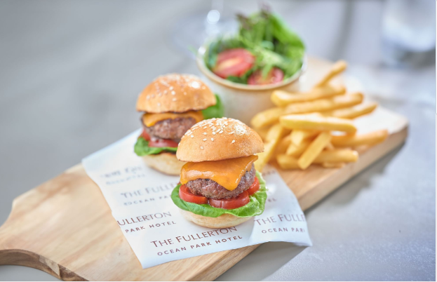 a group of burgers and fries on a wooden board
