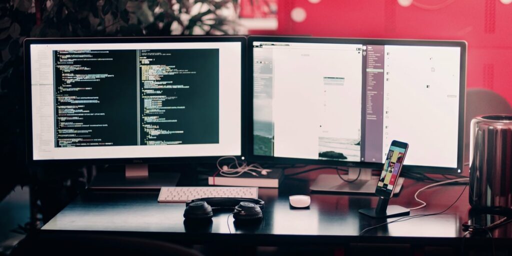 a desk with multiple monitors and a keyboard