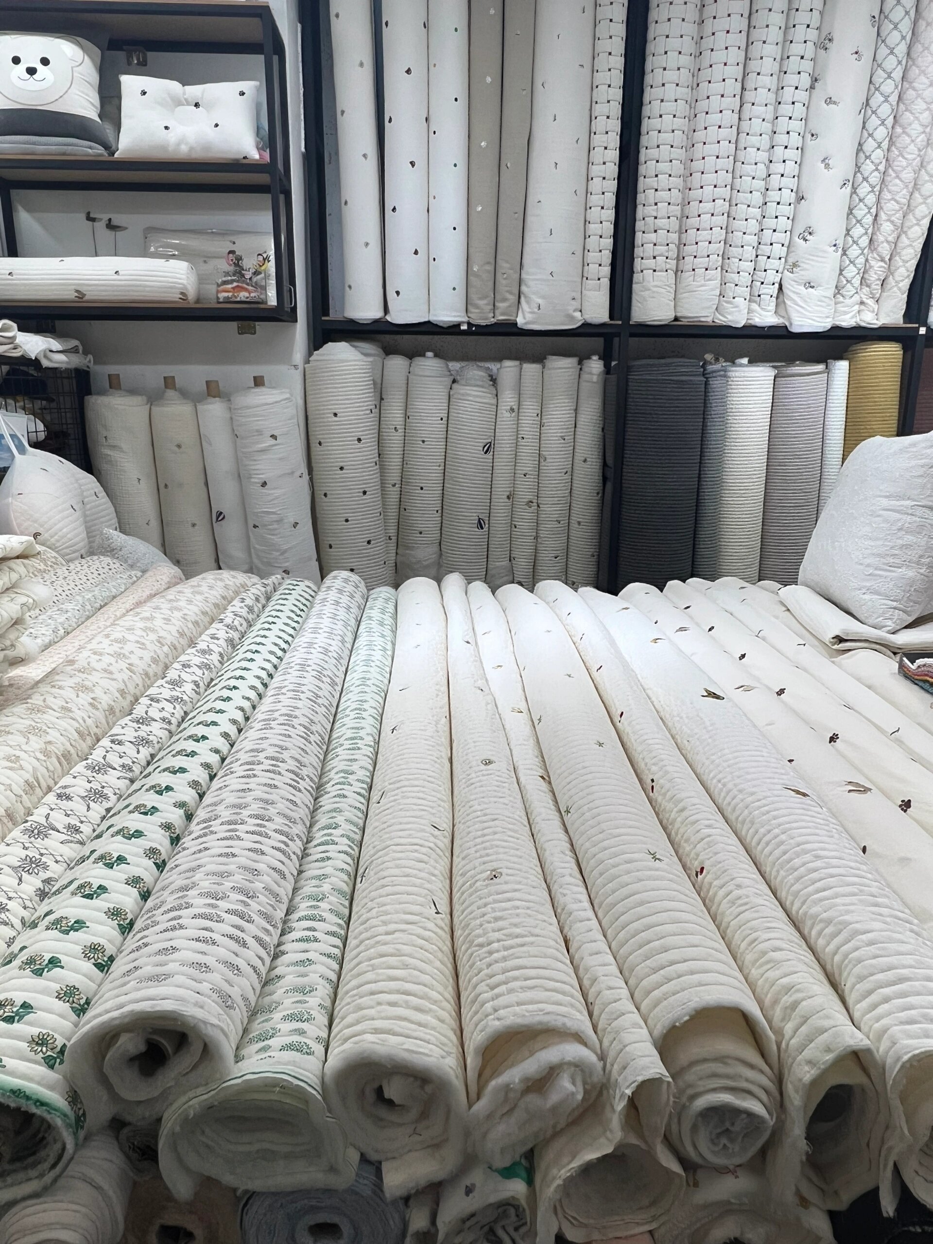 a room with many rolls of fabric