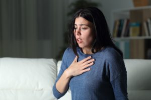 a woman with her hand on her chest