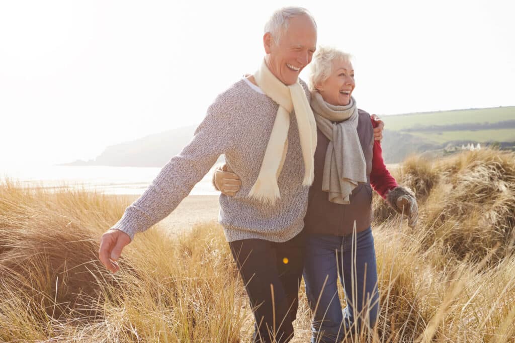 a man and woman walking in a field