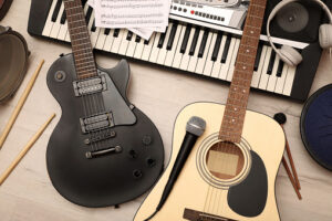 a guitar and a microphone next to a piano keyboard