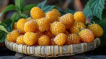 a basket of yellow raspberries