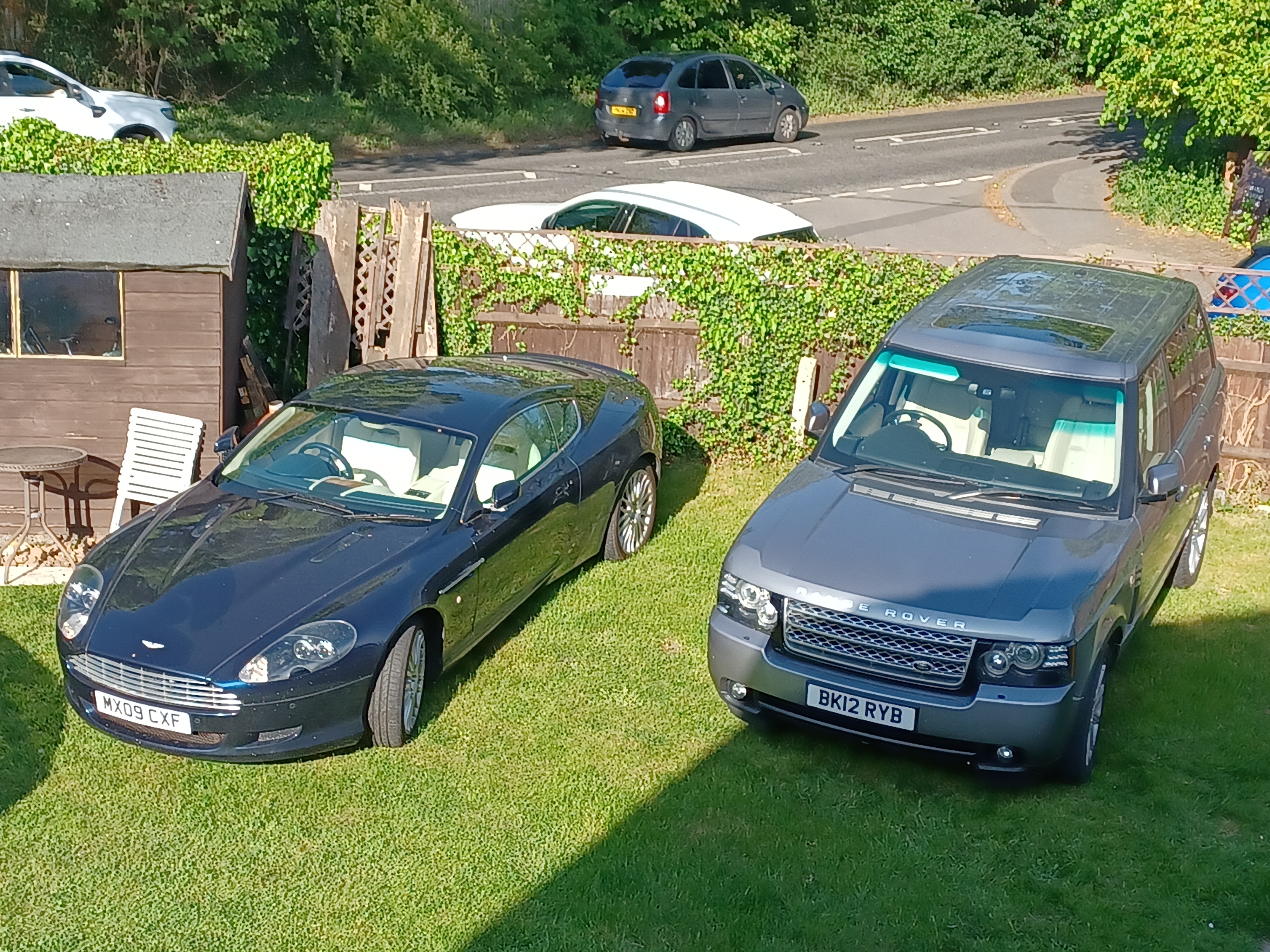 two cars parked on grass