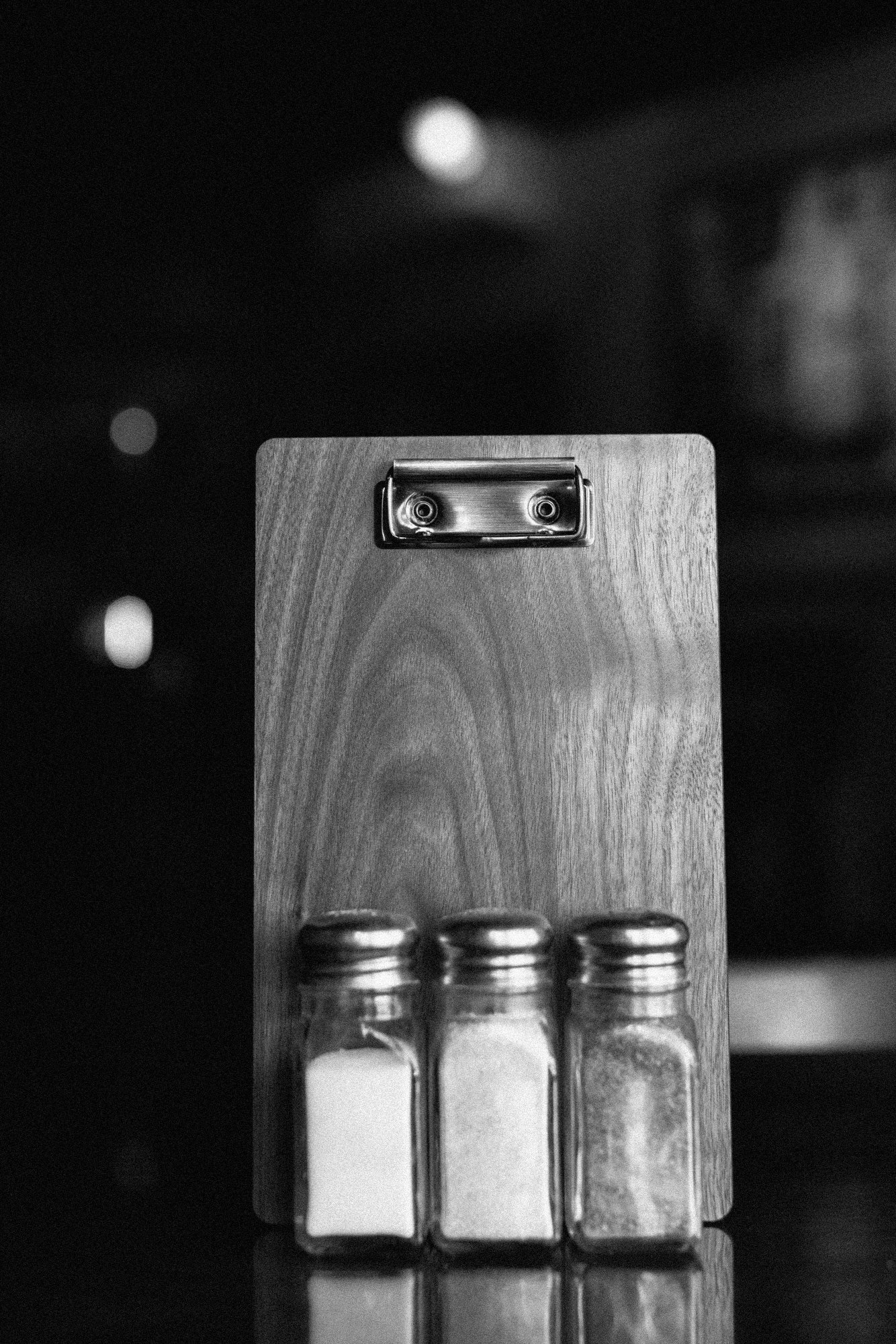 a wooden board with salt and pepper shakers