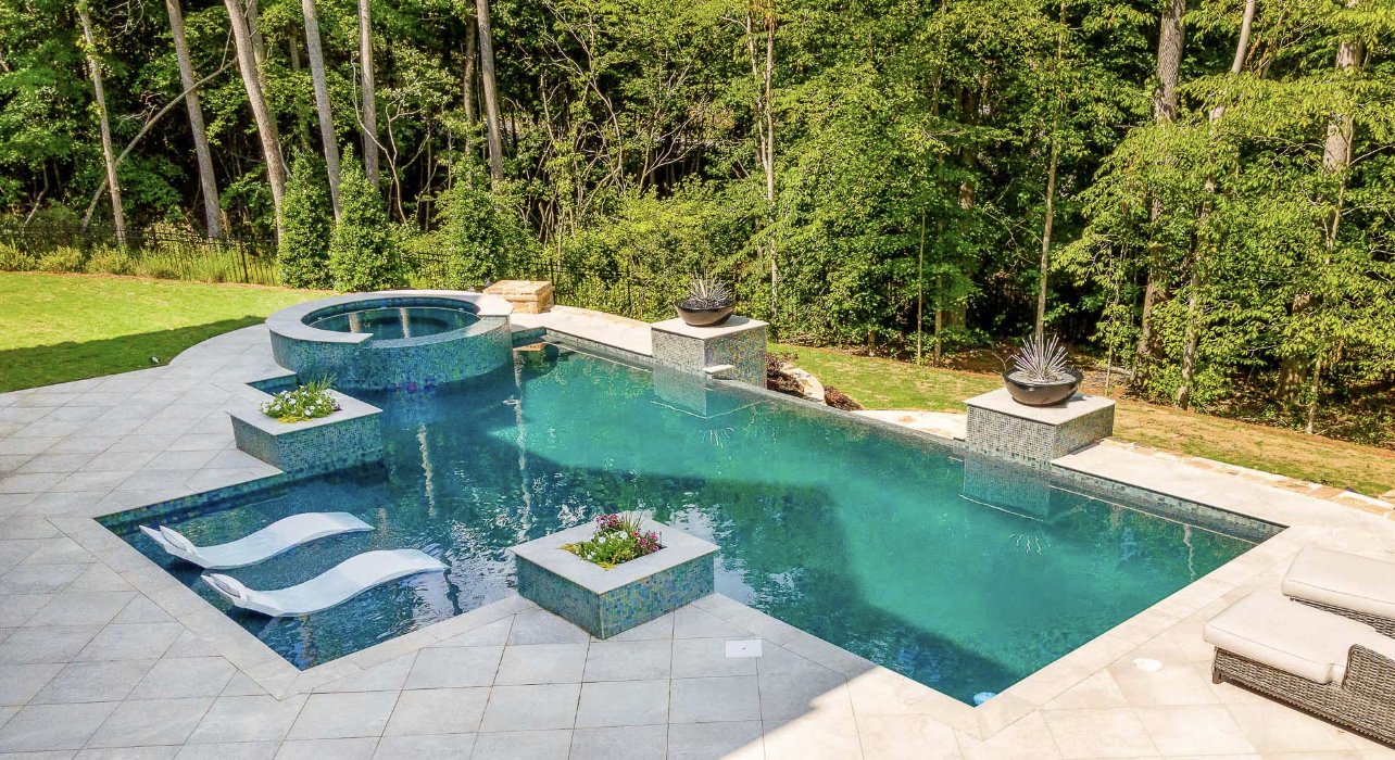 a swimming pool with a jacuzzi and plants