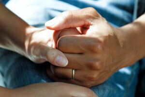 close-up of a man and woman holding hands