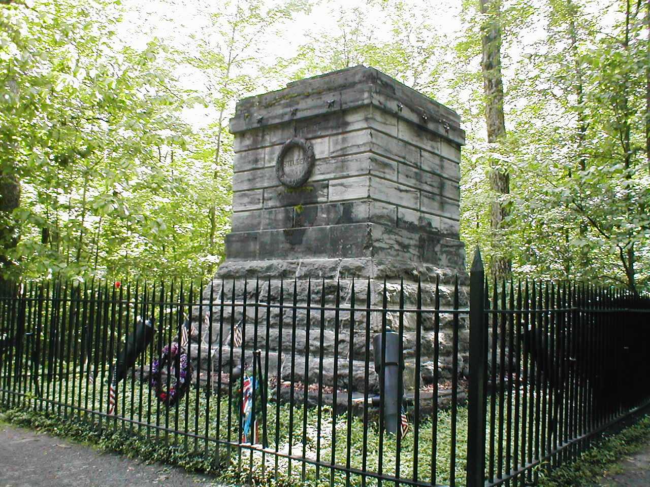 a stone monument in the woods