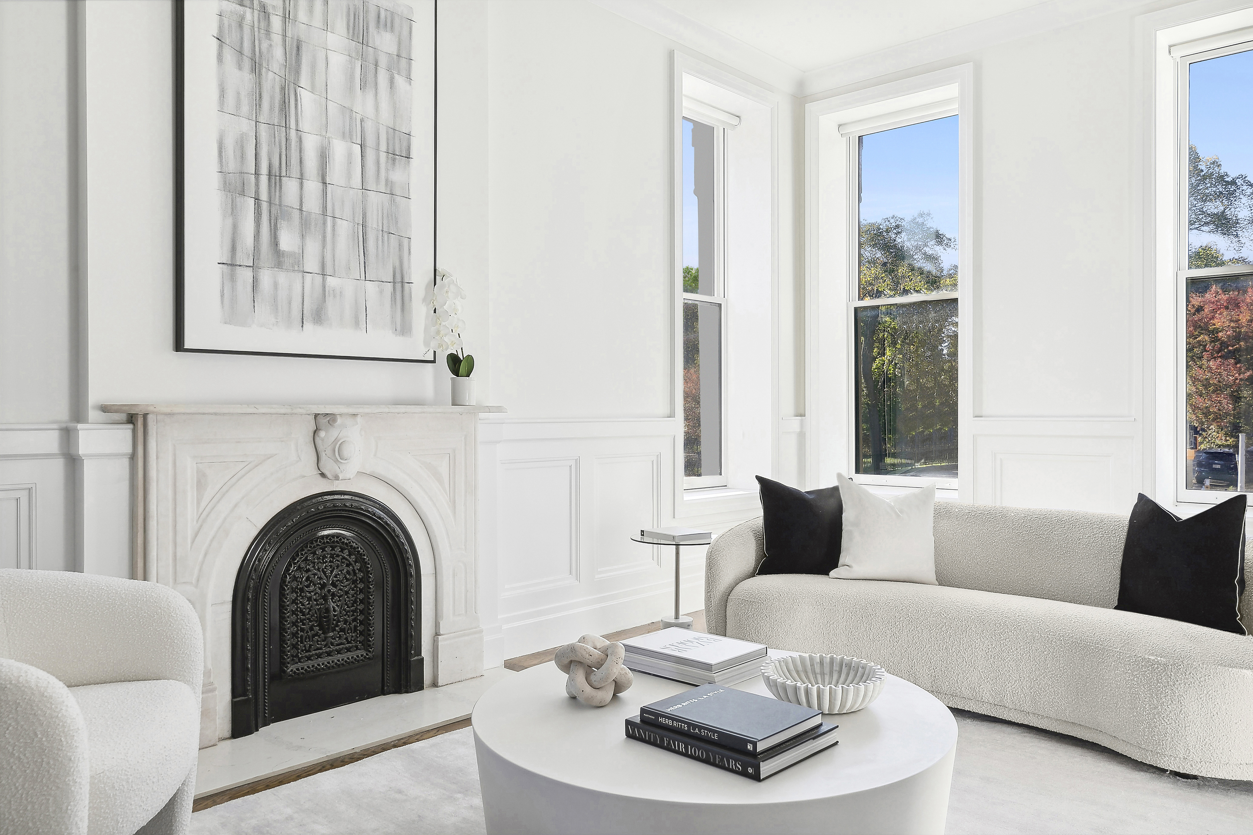 a white living room with a white couch and a white fireplace
