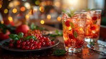 a glass of red liquid with berries on a plate