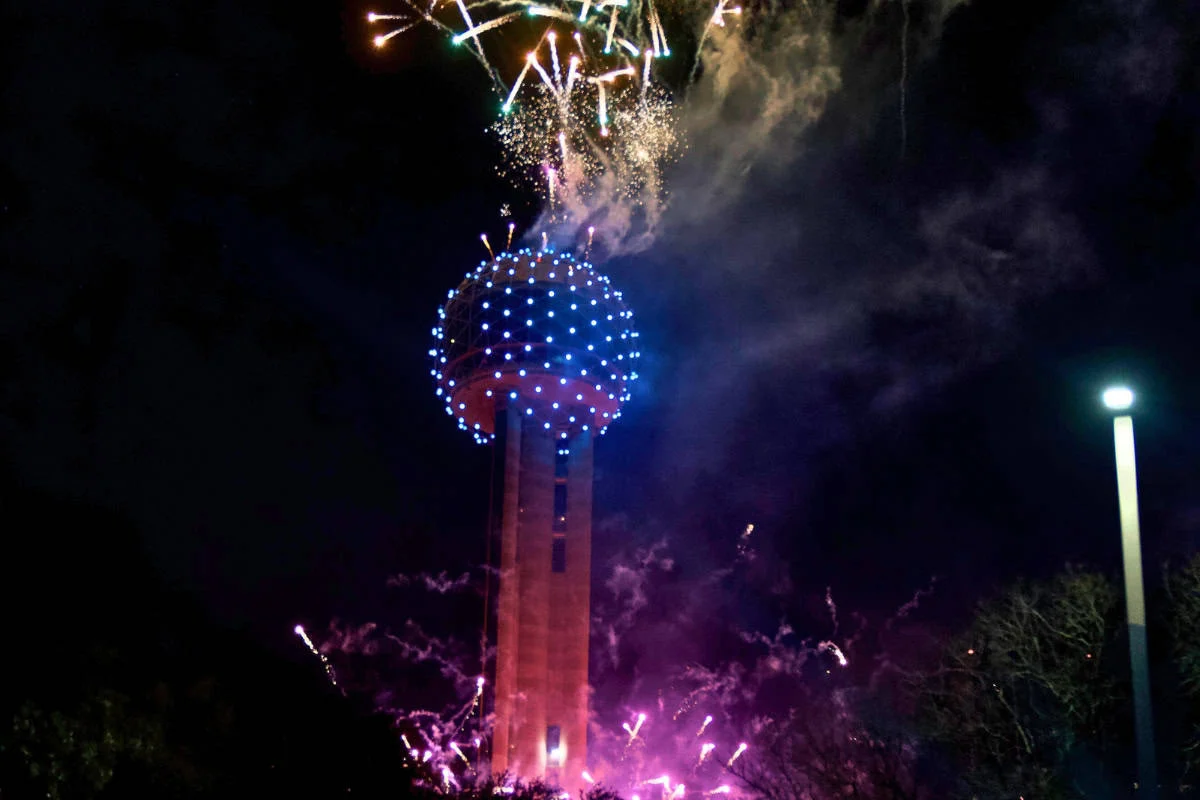 fireworks in the sky above a tower