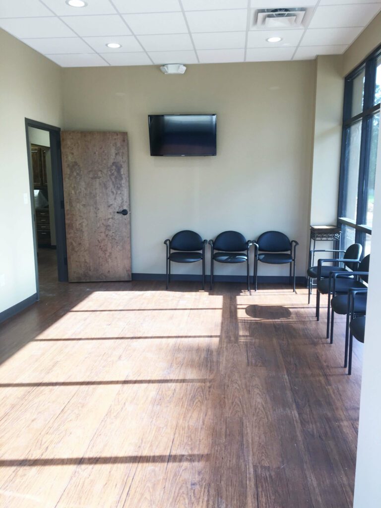 a room with chairs and a television on the wall