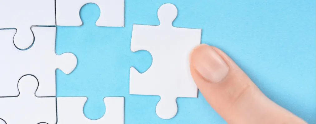 a person holding a piece of puzzle