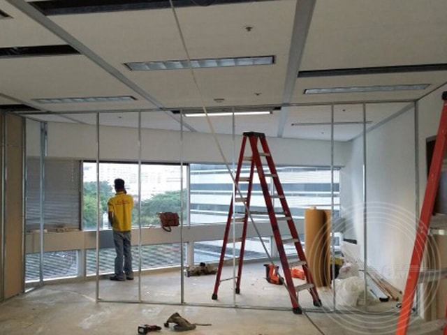 a man standing in a room with a ladder