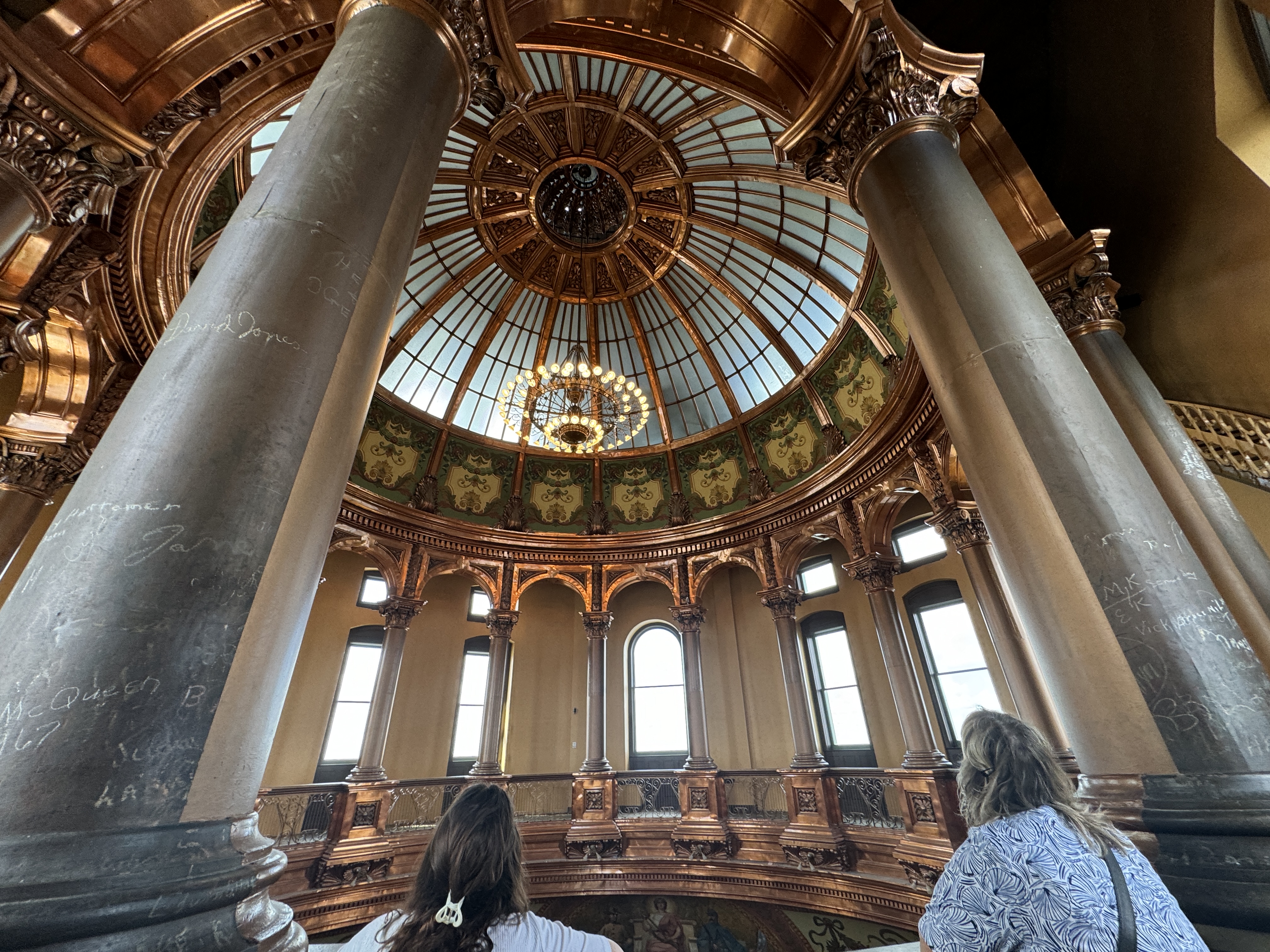 a group of people looking up at a dome