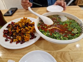 a bowl of soup and food on a table