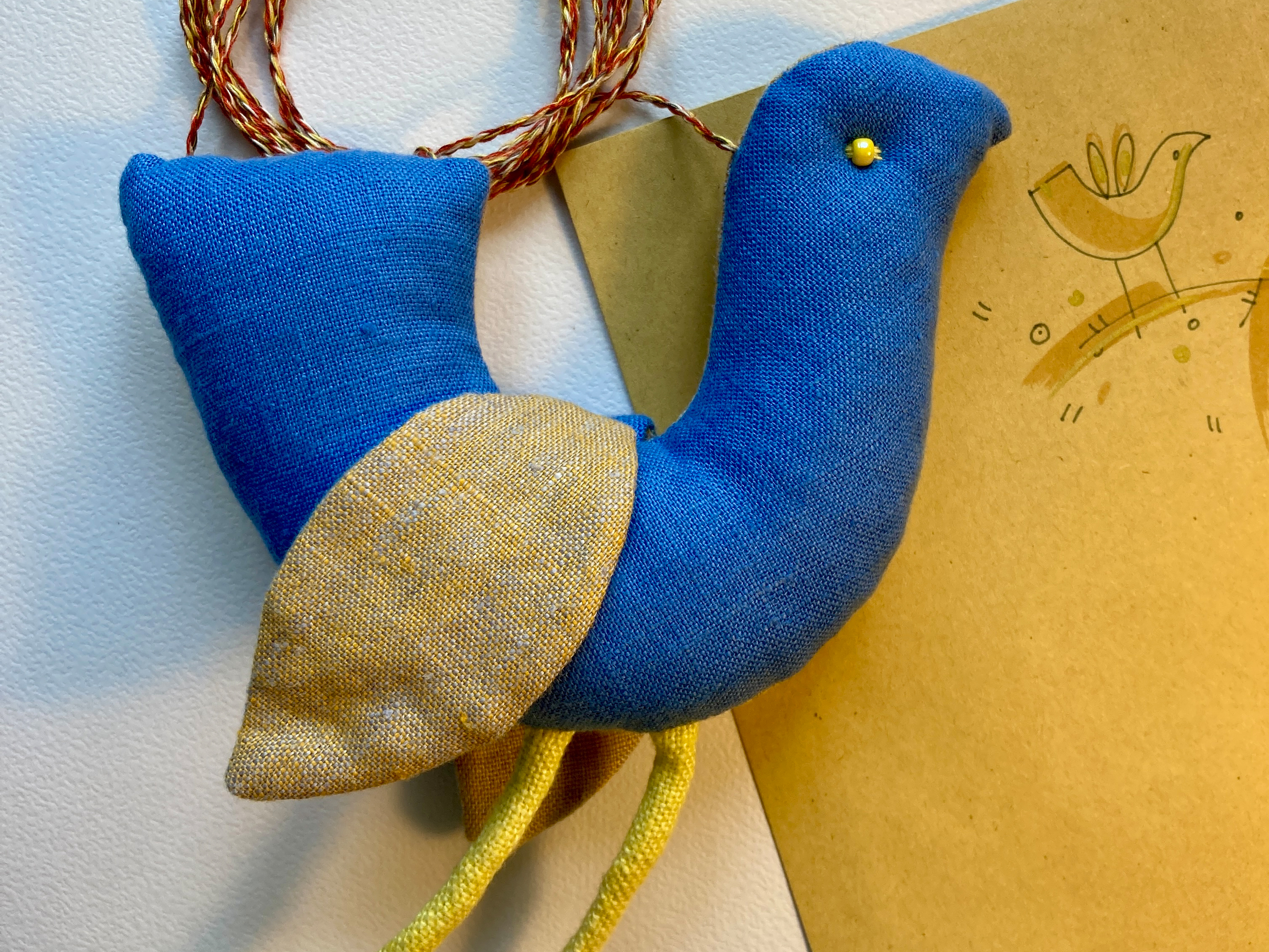 a blue and yellow bird toy