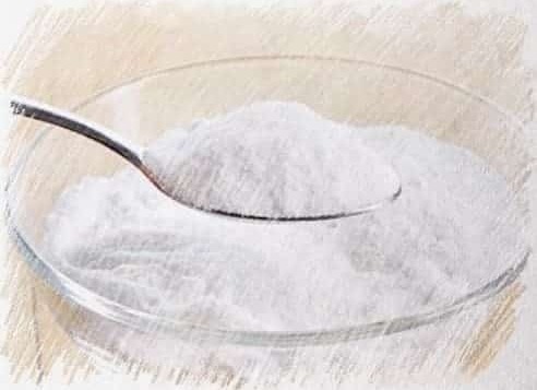 a spoonful of powder in a bowl