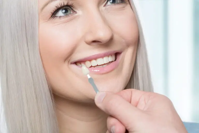 a woman smiling with a toothbrush