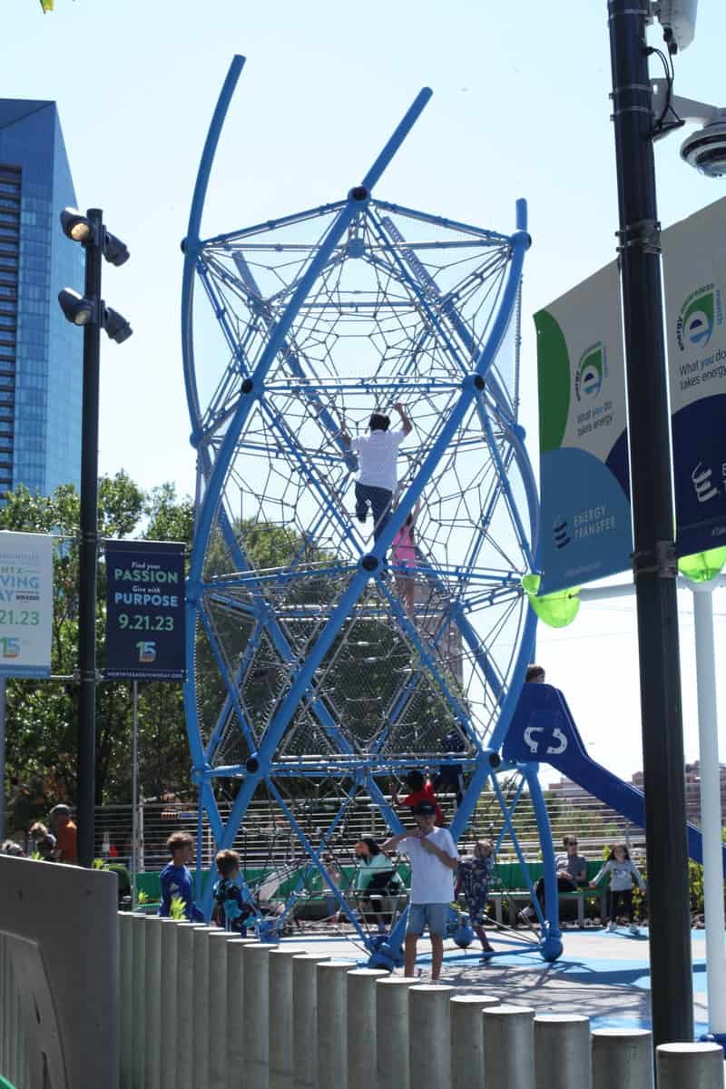 a man climbing a blue structure