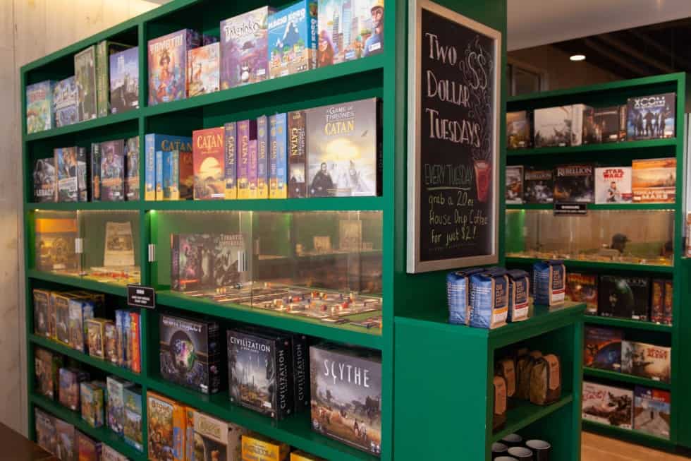 a green shelves with books and other items