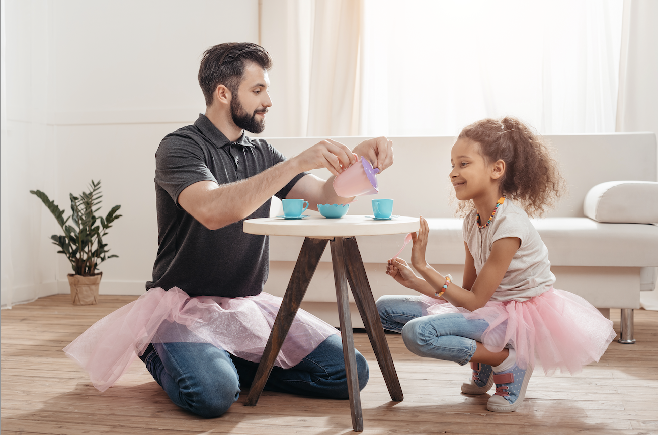 a man and girl sitting at a table