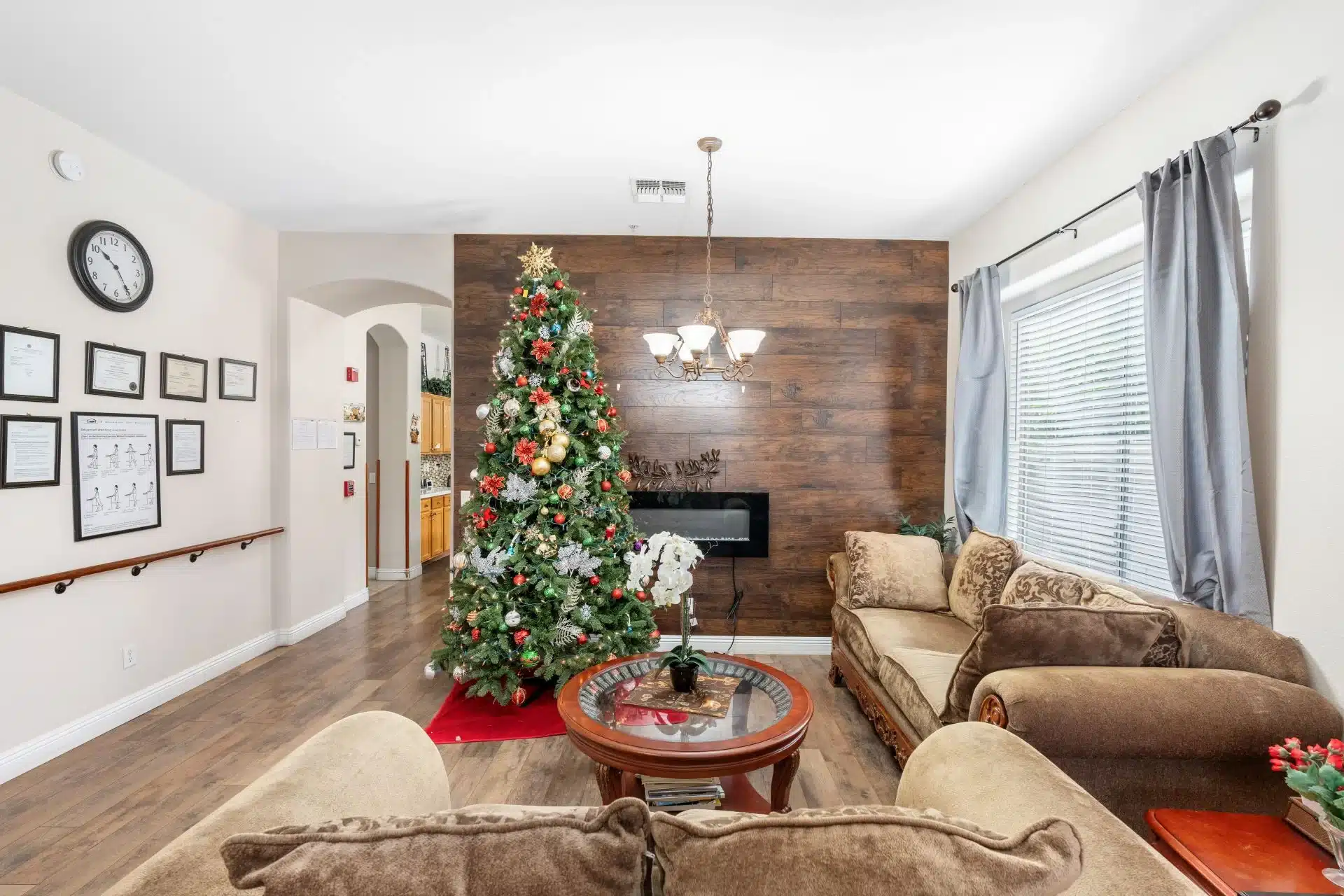 a living room with a christmas tree and a fireplace