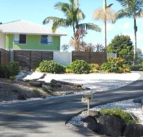 a house with palm trees and a driveway