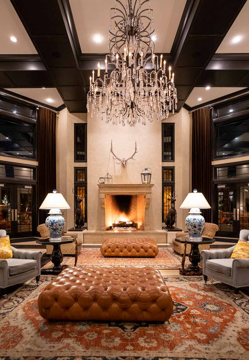 a room with a fireplace and chandelier