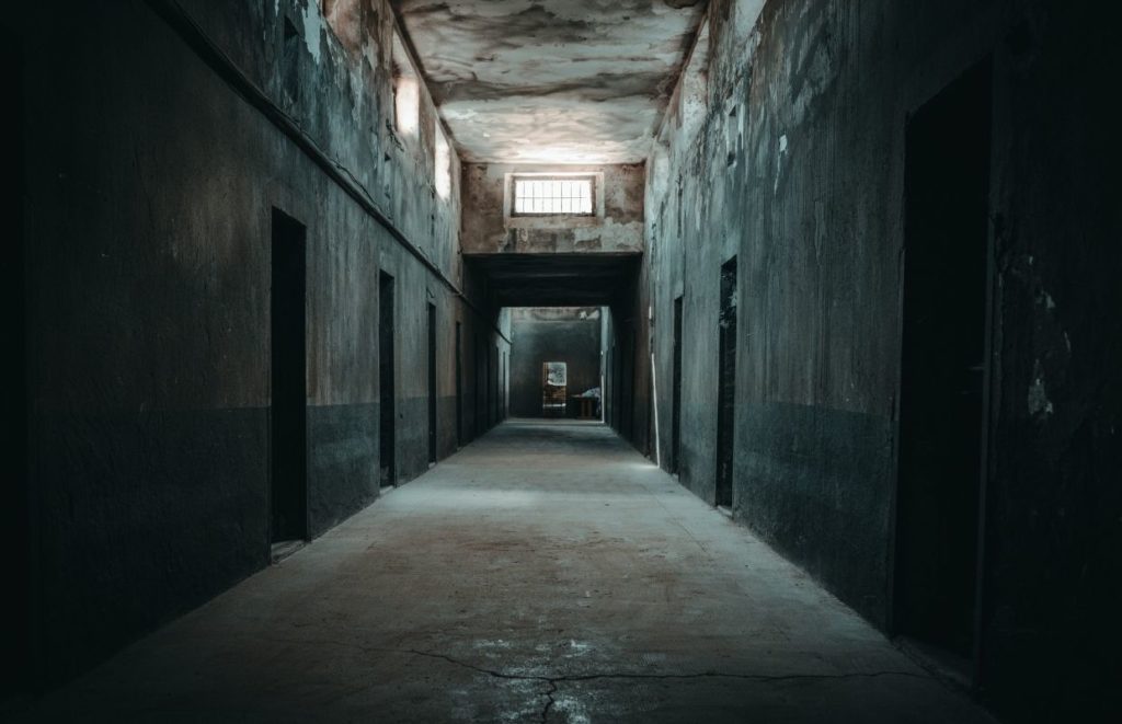 a dark hallway with windows and a window