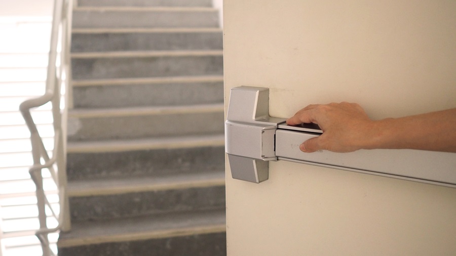 a hand holding a door handle