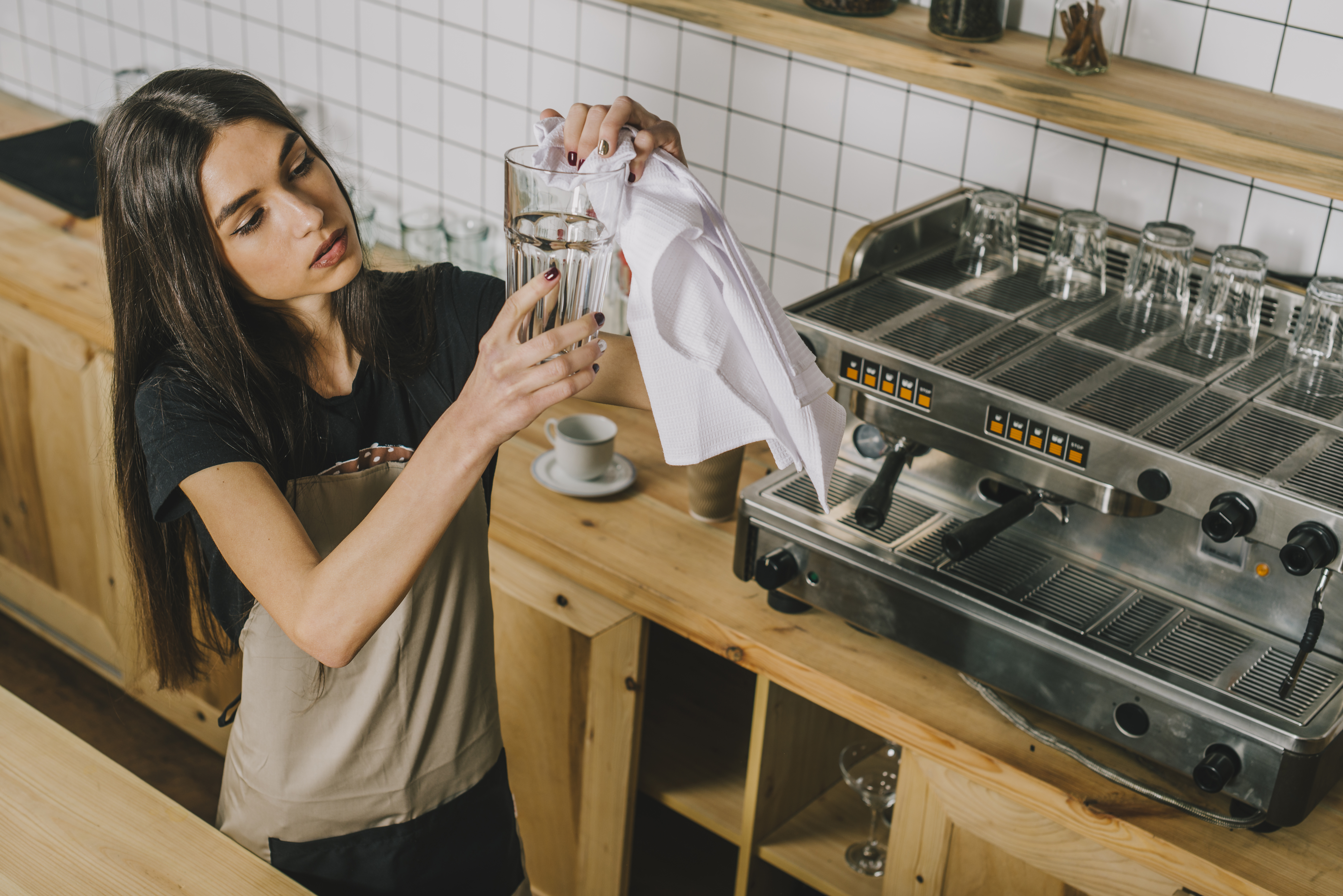 a woman holding a glass with liquid in it