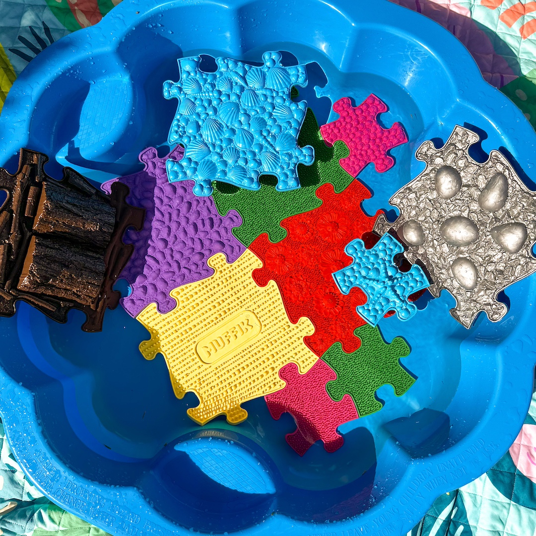 a blue bowl with colorful puzzle pieces