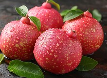 a group of red fruit with green leaves