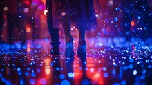 a person's legs in high heels on a floor with lights