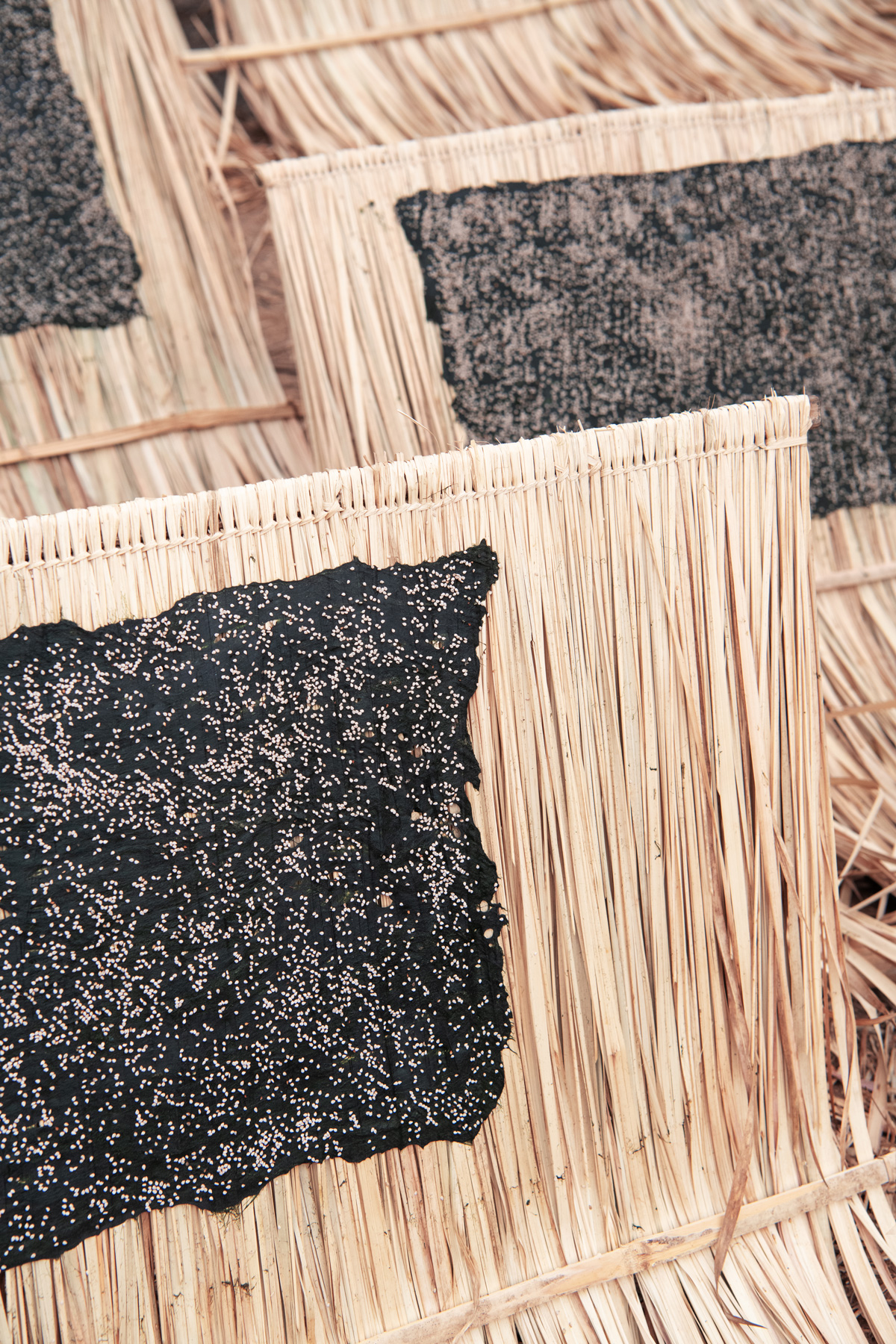 a straw mat with black substance