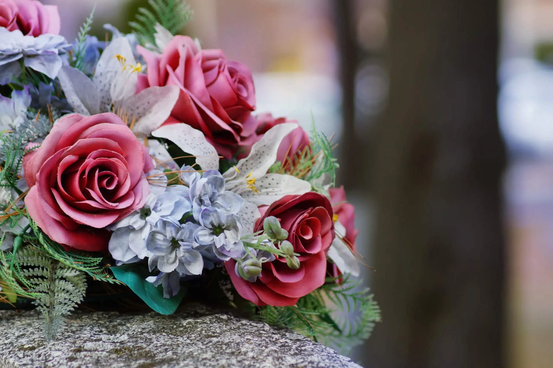 a bouquet of flowers on a stone surface