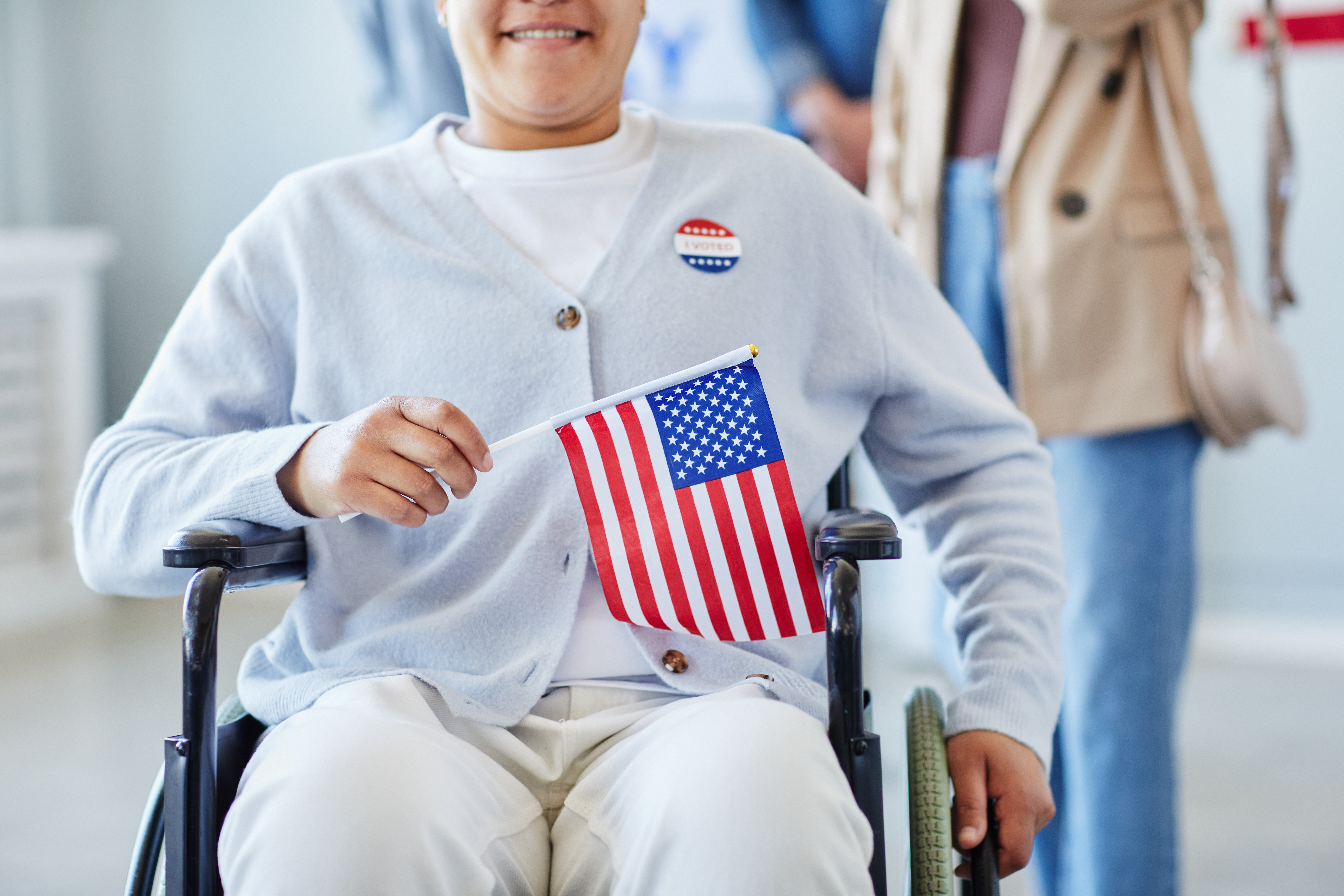 a person in a wheelchair holding a flag