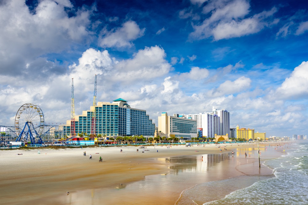 a beach with buildings and a body of water