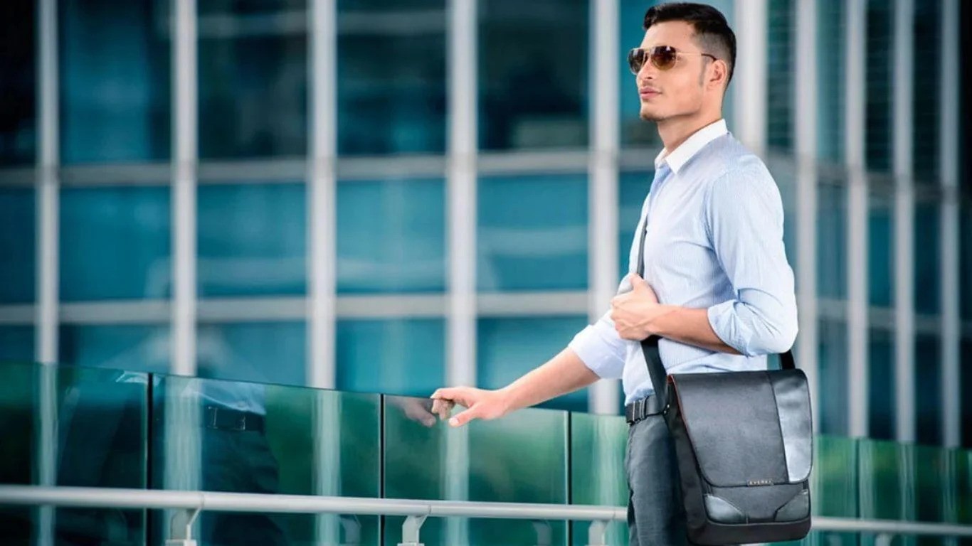 a man wearing sunglasses and a briefcase