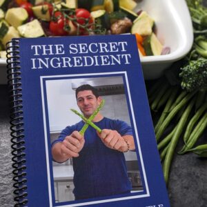 a cookbook with a picture of a man holding vegetables