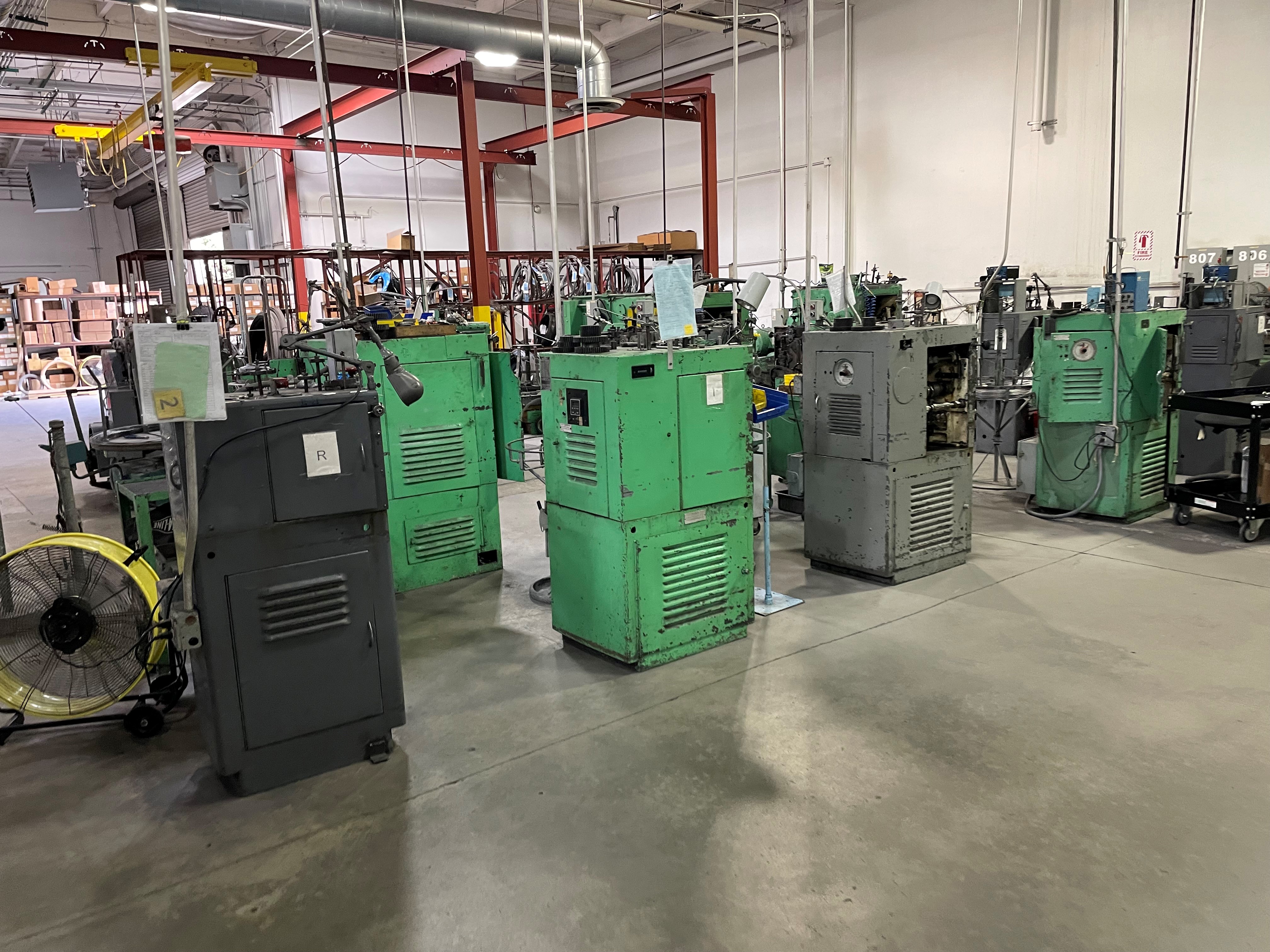 a group of green and grey machines in a room