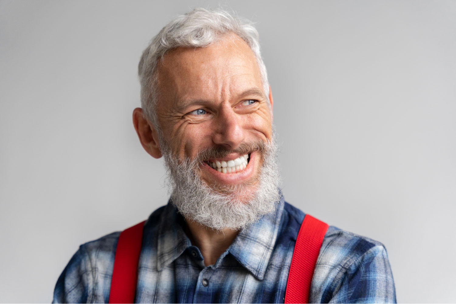 a man with a beard smiling