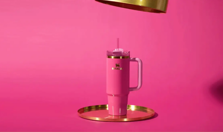 a pink cup with a straw on a tray