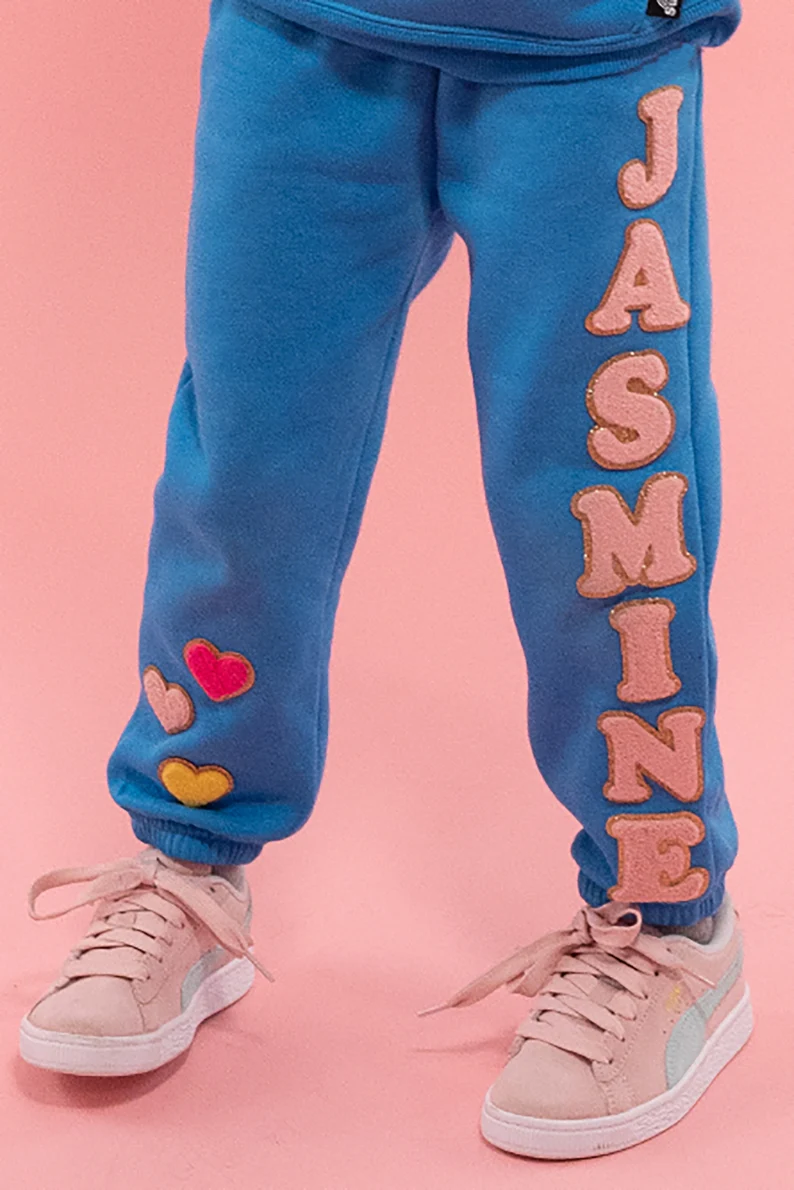 a person wearing blue sweatpants with pink shoes